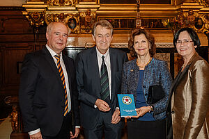 Queen Silvia receives the first copy of the Swedish Luther Breviary.  From left to right: Thomas A. Seidel, publisher Hans Paulsson, Queen Silvia of Sweden, Christine Lieberknecht